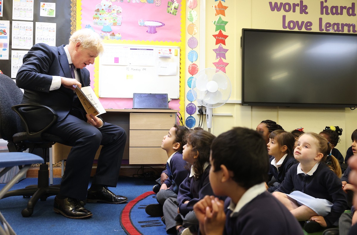 Boris Johnson reads a story to some pupils in a classroom
