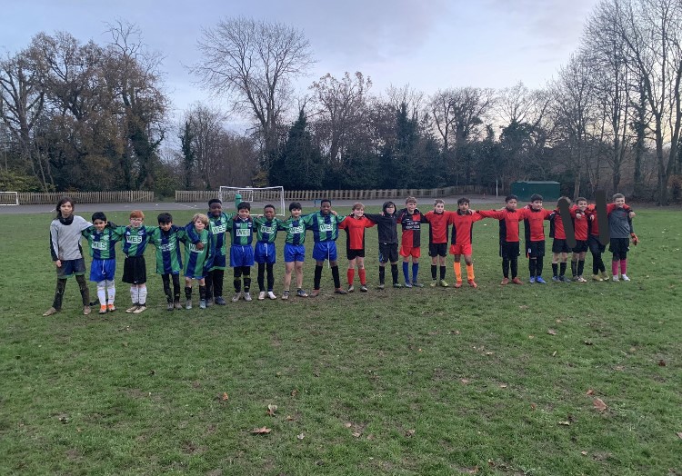 Beechfield & Cherry Tree football teams line up together on the field